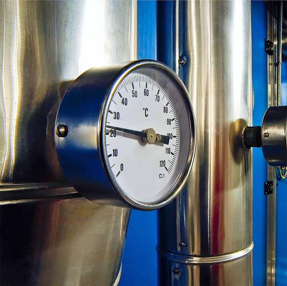 Stainless steel fermentation tanks at a craft brewery with glycol cooling lines